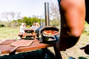 Lifestyle Ooni Fyra 12 Retrieving Pizza-min